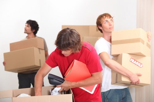 Packed boxes and furniture ready for collection by removals team