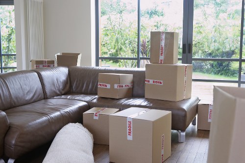 Mover carrying boxes through a Hampton Wick home